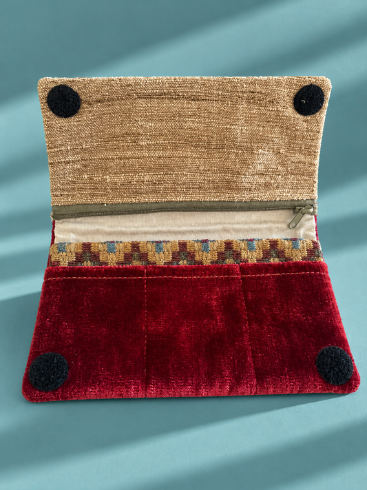 Open Linear Wallet with burgundy slip pockets, gold-toned flap, patterned accent and zippered compartment