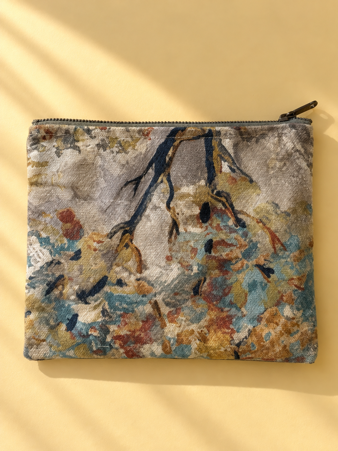 Painterly abstract floral side of the mini-pouch in cream, blue, ochre, and rust