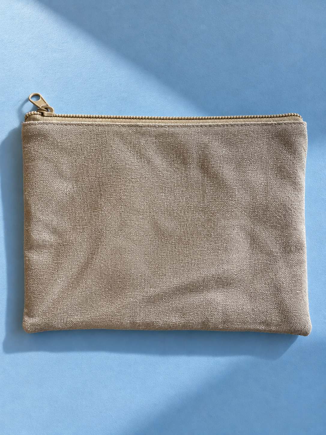 Textured beige reverse of the mega-pouch with beige zip closure