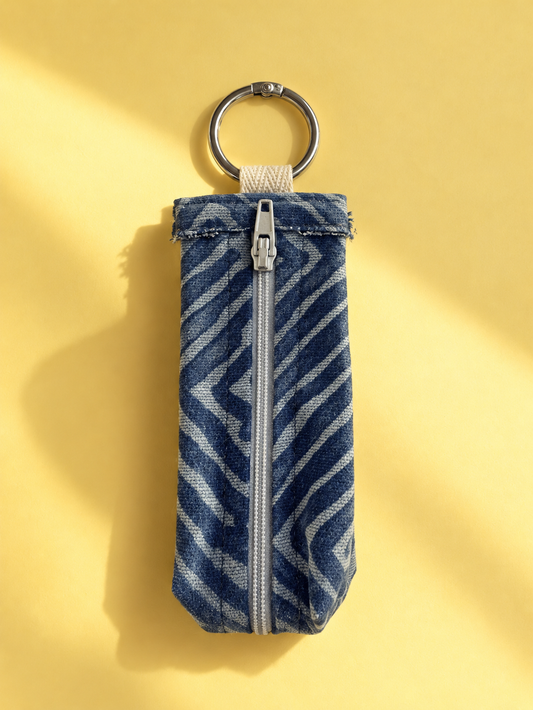 Blue geometric woven keychain pouch with a silver-tone zipper and metal key ring