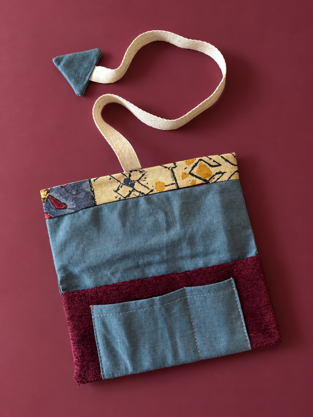Slate blue and burgundy patchwork reverse with slate blue pocket and geometric tapestry trim