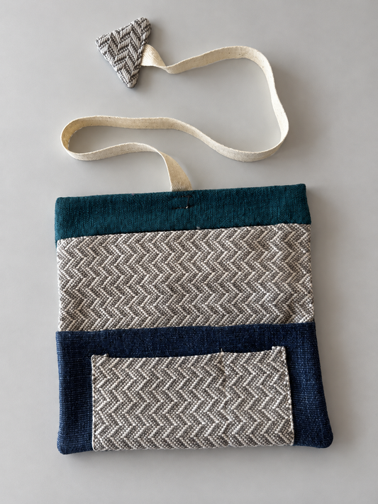 Grey and cream herringbone patchwork pouch with teal top panel, navy lower panel and herringbone pocket