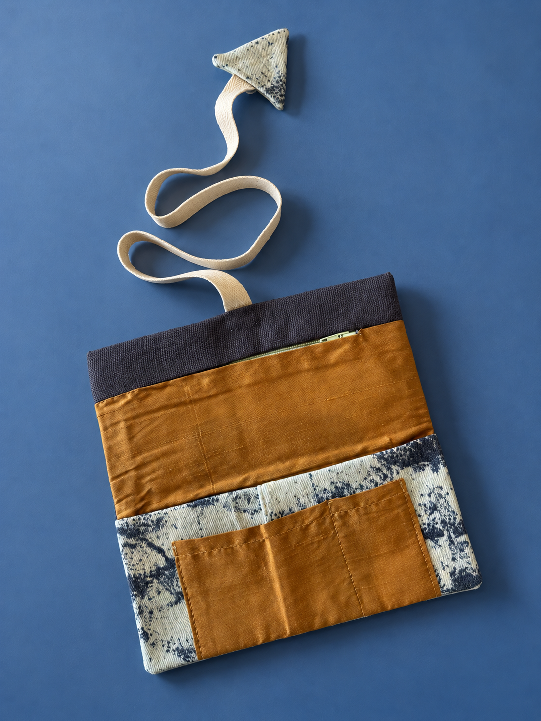 Mustard patchwork side with cream and dark patterned panels, mustard pocket and zipper