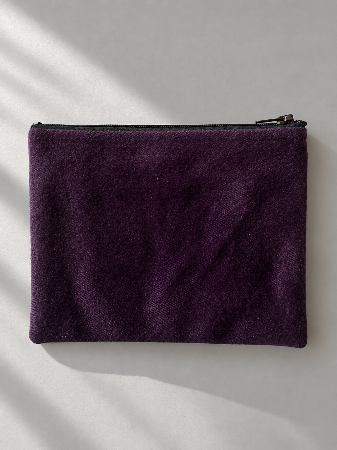 Plain plum side of the zip mini purse with a subtle sheen