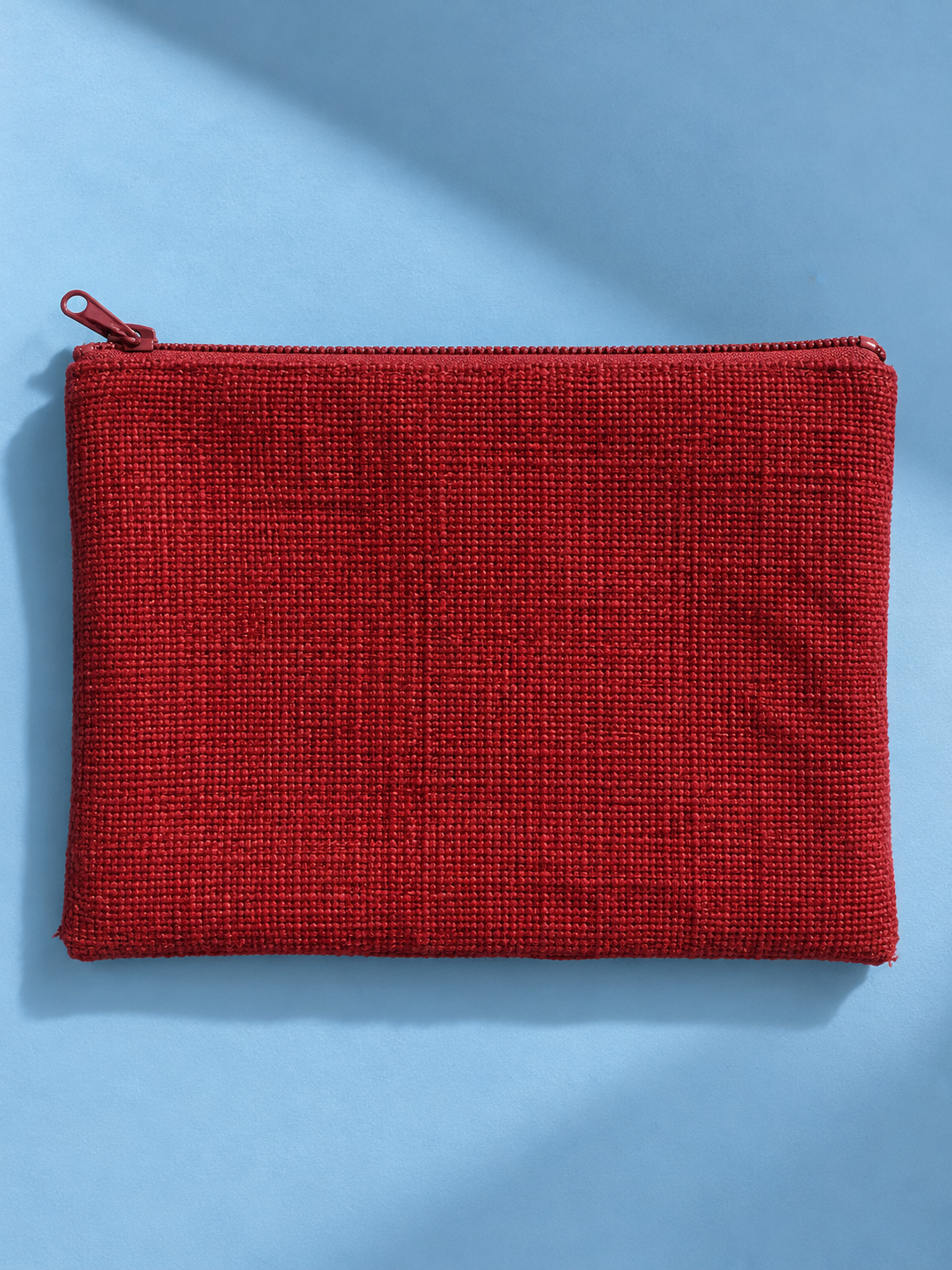 Textured red reverse of the mega-pouch with red zip closure