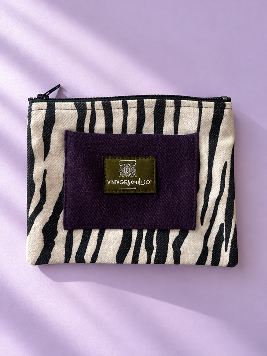 Zebra-patterned mini purse with plum panel, Vintagesoul 101 label, and black top zipper
