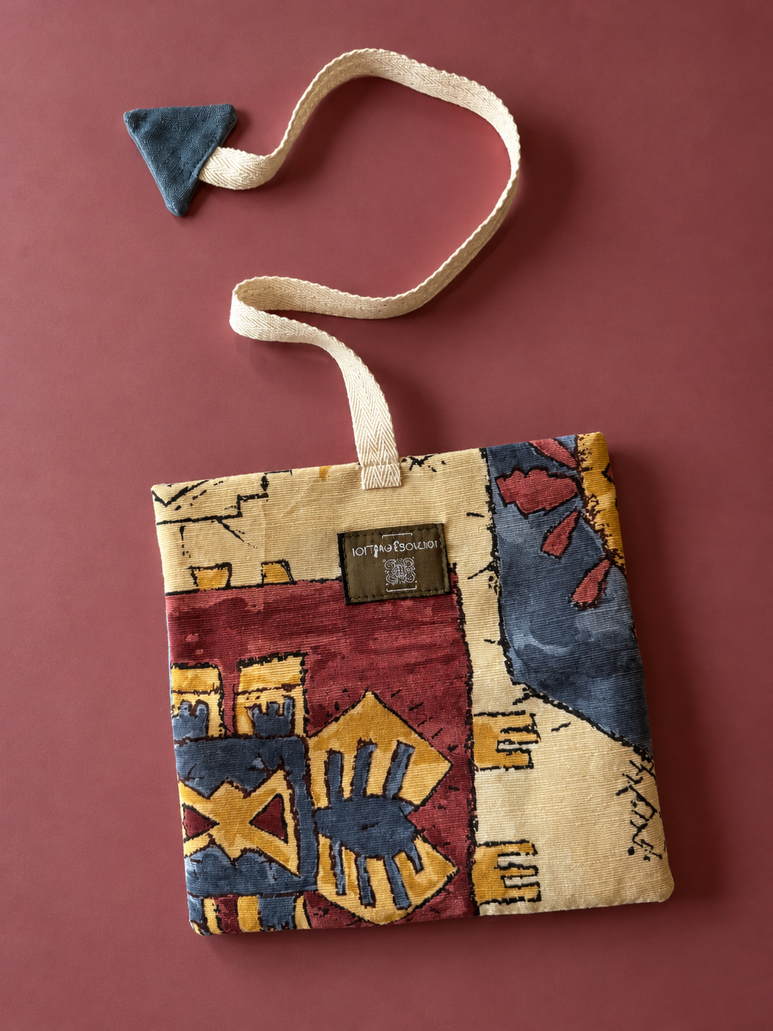 Cream, burgundy, mustard and slate blue geometric tapestry pouch with cream woven strap